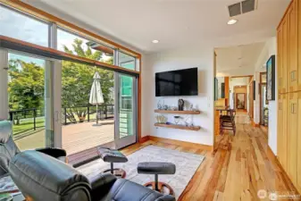 Family room with large TV and floating Shelves.