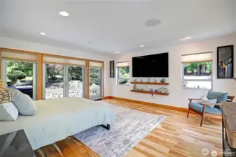 Spacious Master Suite with your large TV and floating shelves.