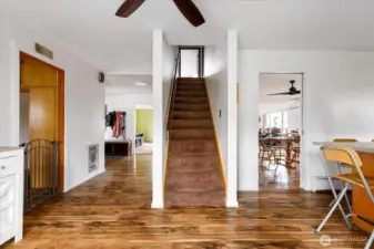 View from the back entry, looking toward the front entry, the stairway, and the entrance to the dining room.