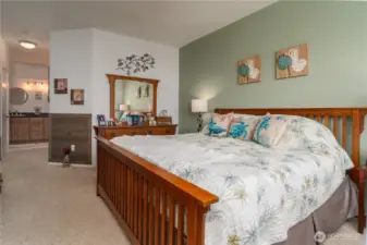 Main bedroom with wood wainscoting, bathroom in the rear