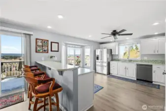 Convenient eating bar opens to the updated kitchen.