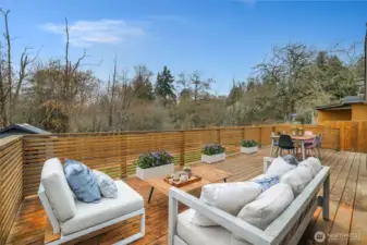 Expansive deck, perfect for entertaining. Planters are virtually staged.