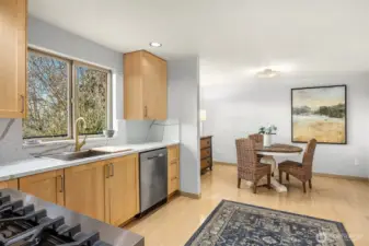 The oversized sink and brushed gold faucet overlook the deck and views.