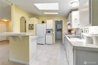 Kitchen leads to utility room with double pantry, washer/dryer and back door.