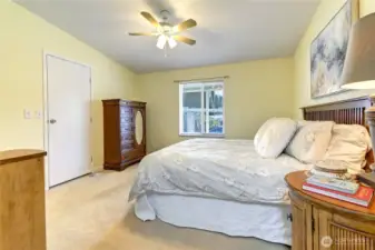 Door here leads to walk in closet with hanging bars on 3 sides.