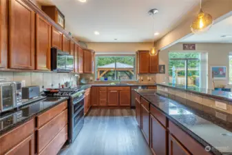 High-end stainless steel appliances and gleaming granite countertops gives this kitchen a luxurious feel and the warm wood toned cabinets has ample storage for all your gadgets and flatware.