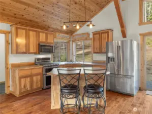 Lots of storage space in this custom kitchen - spouted maple cabinets , SS refrigerator and dual oven (propane).