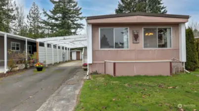 Carport fits one car with room in the driveway for another car!