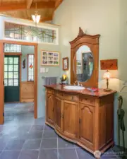 Main bathroom, looking toward entry to main house, with repurposed antique sideboard as vanity