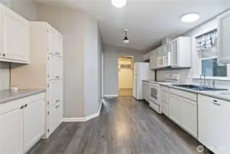 Kitchen looking toward the utility room; main bedroom is at the end of the hall on the left