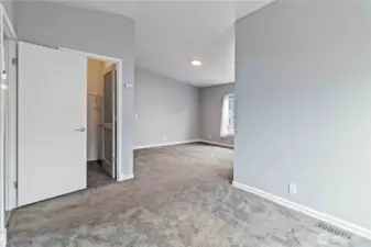 Main bedroom with sitting area, walk-in closet, and ensuite bath