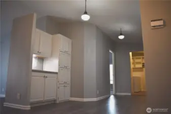 Looking from the kitchen to main bedroom door on the left, utility on the right