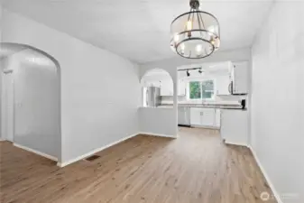 Dining Room looking toward Kitchen. Hall leads to secondary bedrooms and full bath.