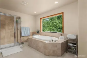 Soak up paradise from the expansive primary suite’s soaking tub.