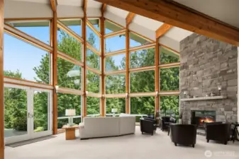 The heart of the home is an open living room, boasting 30' ceilings, stone fireplace and adorned with beautiful beams.