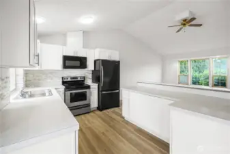 Large kitchen area with plenty of cabinets and countertop space