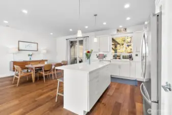 Kitchen is open to the dining area with access to the deck through sliding door
