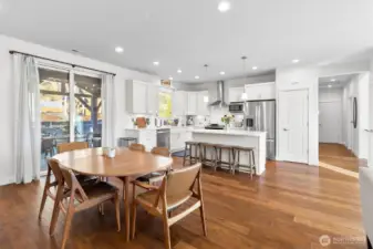 View from living room down hallway, to kitchen, dining and covered deck