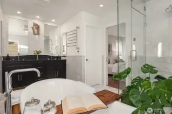 Primary Bedroom on this level is a spacious retreat with all the amenities needed for a relaxing and rejuvenating atmosphere.  Make life simple with lighted closet organizers. In-spa bath with glass enclosed steam shower, free standing bathtub, heated floors and towel rack, dual sinks and plenty of cabinet space. High quality Kohler fixtures, mosaic marble, pewter sconces, hand rubbed antique brass, dual Robern medicine cabinets.