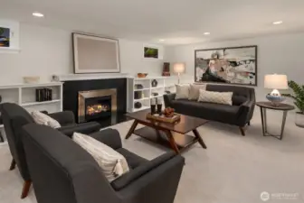 The gas log fireplace with Granite Ebony honed surround and custom mantle is the stunning centerpiece of the room.