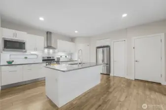 White piano finish cabinets w/Blum pull-down shelves and quartz countertops