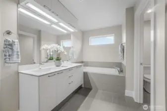 Primary bath includes double sinks, soaking tub, walk-in shower, bidet and tile floor