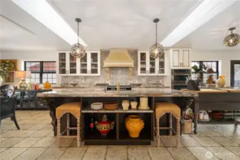 kitchen island with tons of natural light from skylights wrapped in shiplap accents