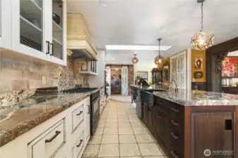 view from the breakfast nook area back through the kitchen to the back entry door, mud room, and office/den