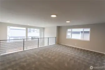 Expansive Leisure Room/Loft, facing wall-sized windows, is the perfect space for entertainment.