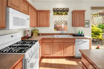 Equipped with all new (2020) white GE appliances including a 5-burner gas cooktop/stove, French door refrigerator, and dishwasher.  A microwave and an updated kitchen sink.