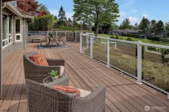 Sun drenched  entertainment sized low maintenance composite deck overlooking the 4th hole and green