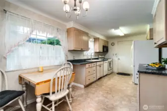 eating space in the kitchen with view to H. Ave.  garage access into the kitchen, and dining room is to the left.