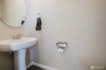 Main-level half bath with neutral tones.