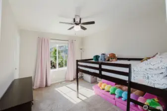 Bedroom with ample light and space for bunk beds.