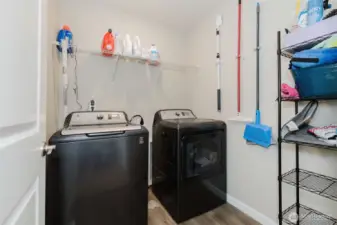 Laundry room with washer/dryer and storage.