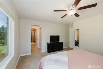 Primary bedroom with large window and direct bath access.