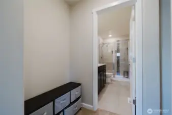 Primary suite hallway leading to bath.