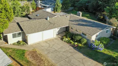 Wonderful single-level living, and a very modest street view that will surprise you once inside!  Attached studio has separate entrace and parking, seen here on left.