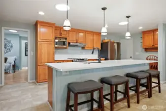 Pendant and recessed lights, subway tile backsplash, and beadboard details speak to the style and quality.