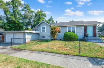 This classic home with a cheerful turquoise door sits on a generous corner lot, offering timeless curb appeal and historic neighborhood charm.