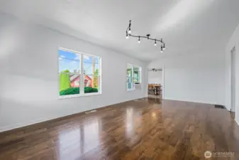 Featuring large picture windows, gleaming wood floors, and ample wall space for décor, this room serves as the heart of the home.