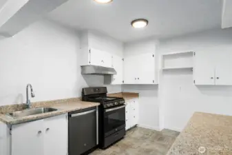 Ample cabinet and counter space with a mix of open shelving and closed storage.