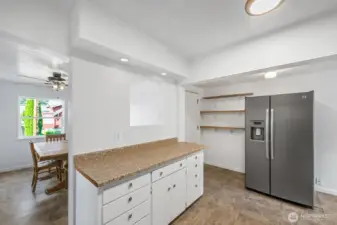 Easy-clean counters, large sink, and efficient design with sightlines into the dining area.