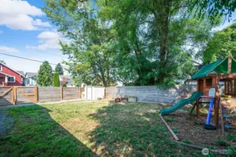 Fully fenced for privacy and security, the side yard offers plenty of space for gardening, play, or future landscaping.