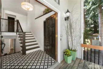 From the front porch looking in, the recently tiled floors are a tasteful change from what you normaly see in most homes, and the stairs and spindles have been updated to showcase the stairs.