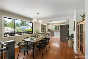 Open concept dining off of the kitchen- notice the cohesiveness of the laminate floors through the whole upper level.