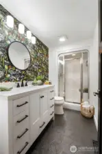 This gem is the Primary EnSuite bath- Recently re-done with Embossed tile floors, vanity, toilet and some good lookin wallpaper to greet you in the morning!