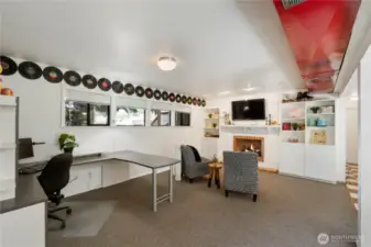Theis area offers extra space for a plethora of options!  Also features a wood-burning fireplace, with stylish storage.