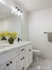 Main Bathroom has quartz counters and dual undermount sinks and lovely tile flooring.