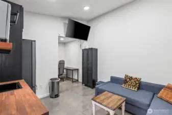 Pool room with kitchenette and concrete floors